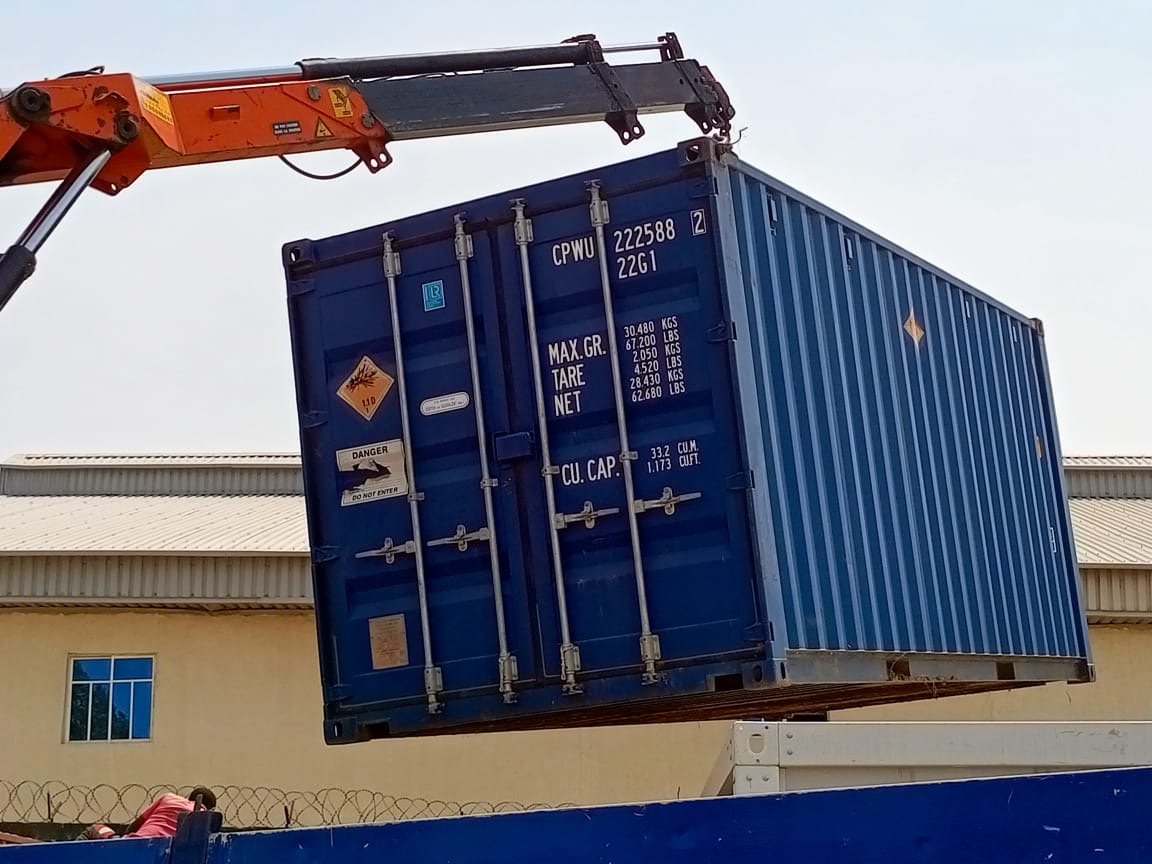 A 20ft container being craned onto a truck for delivery