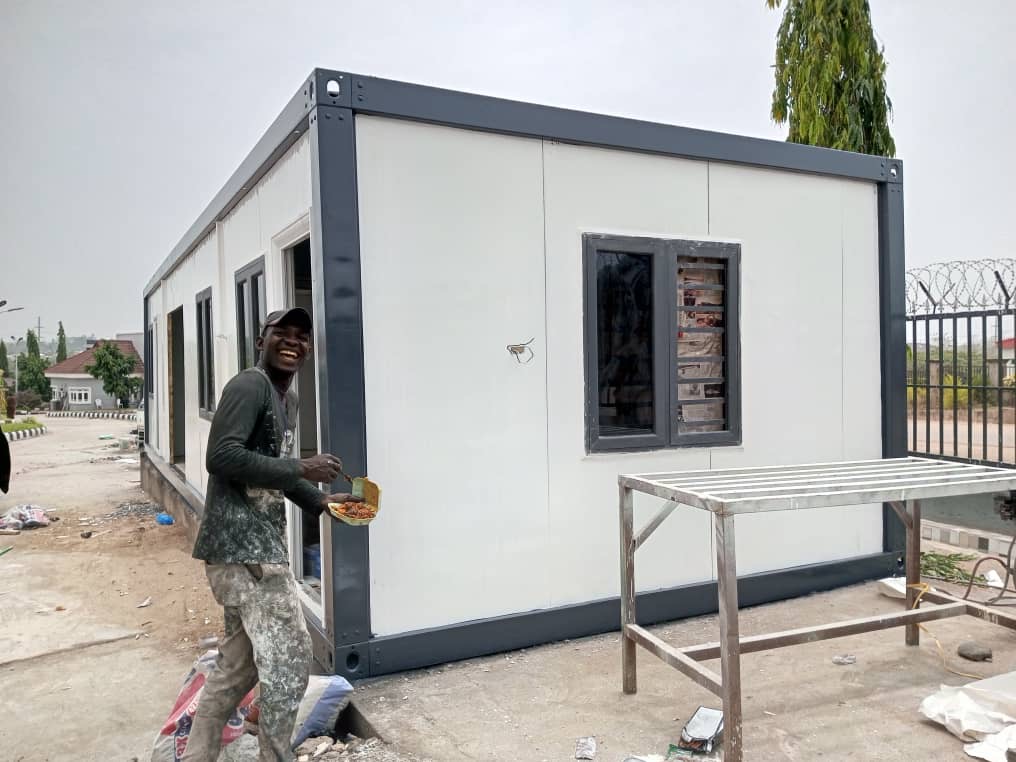 Long grey and white porta-cabin on a paved site