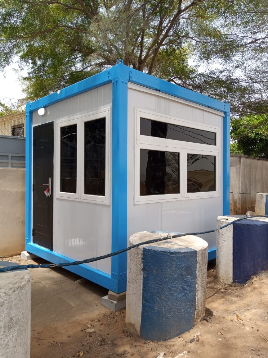 Blue and white container cabin used as a site facility